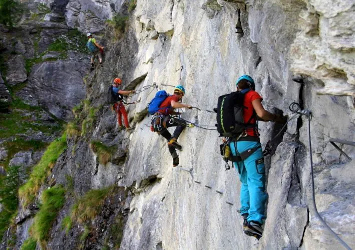 Group climbing the cabled rock face